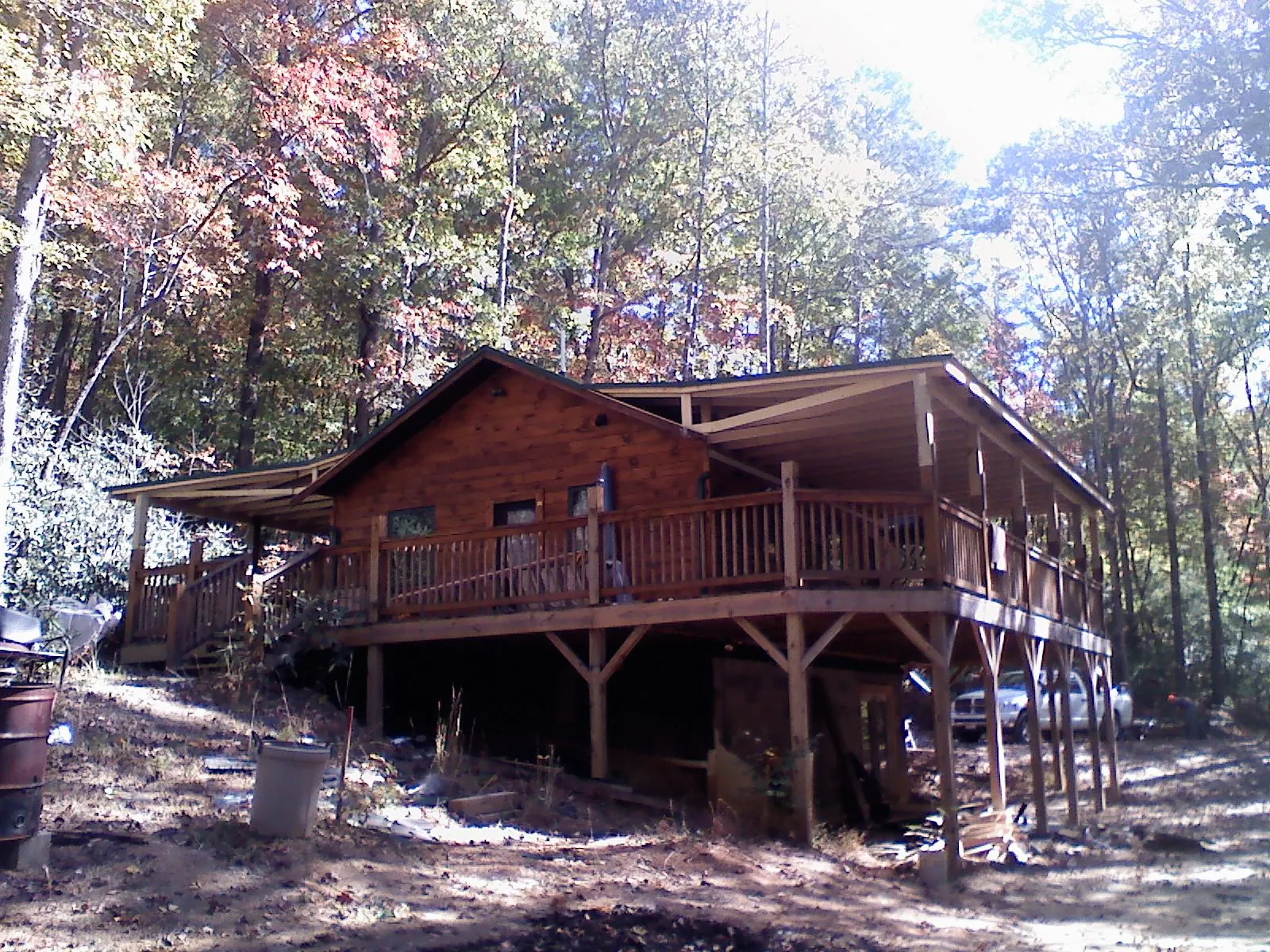 Log cabin with a wraparound porch and metal roof in the fall in Ventura