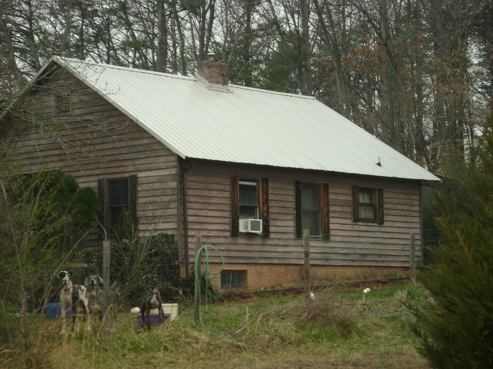 White metal roof on an old wood sided farmhouse, from a Metal Roof Installation job in Ventura